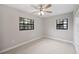 Bedroom featuring two windows providing natural light, neutral paint, and ceiling fan at 1180 E Hill Ct, Bartow, FL 33830