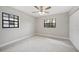 Bedroom with a ceiling fan and natural light from two windows at 1180 E Hill Ct, Bartow, FL 33830