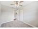 Bedroom featuring closet, ceiling fan, and doorway to attached bathroom at 1180 E Hill Ct, Bartow, FL 33830