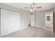 Bedroom with ceiling fan, closet, and a doorway to an attached bathroom at 1180 E Hill Ct, Bartow, FL 33830