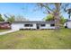 Charming single-story home featuring a well-maintained lawn, fresh exterior paint, and a classic front door at 1180 E Hill Ct, Bartow, FL 33830