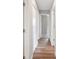 Hallway featuring wood-look flooring, neutral paint, and white doors to various rooms at 1180 E Hill Ct, Bartow, FL 33830