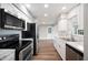 Well-lit kitchen with stainless steel appliances, white cabinets, and marble countertops at 1180 E Hill Ct, Bartow, FL 33830