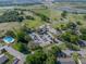 Aerial view featuring a swimming pool, parking lot, and green areas, offering a glimpse of the community's amenities and layout at 121 Greenfield Rd, Winter Haven, FL 33884