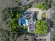 Overhead view showing the home's layout, pool area, driveway, and surrounding trees at 121 Greenfield Rd, Winter Haven, FL 33884