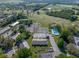 Aerial view of a community featuring tennis courts and swimming pool, highlighting the recreational amenities available to residents at 121 Greenfield Rd, Winter Haven, FL 33884