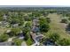 An aerial view showcases a home with a pool surrounded by a golf course and mature trees at 121 Greenfield Rd, Winter Haven, FL 33884