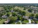 Aerial view features a home with a pool, set against a backdrop of a golf course at 121 Greenfield Rd, Winter Haven, FL 33884