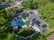 Aerial view of the property featuring a solar panel roof, backyard pool, and lush landscaping at 121 Greenfield Rd, Winter Haven, FL 33884