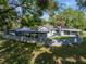 Fenced backyard with patio, pool, and solar panels, offering privacy and outdoor enjoyment at 121 Greenfield Rd, Winter Haven, FL 33884