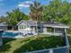 Aerial view of home with pool and solar panels offering relaxed outdoor living and energy efficiency at 121 Greenfield Rd, Winter Haven, FL 33884