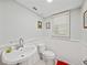 Traditional bathroom with beadboard paneling and white fixtures is bathed in natural light at 121 Greenfield Rd, Winter Haven, FL 33884