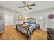 Comfortable bedroom with wooden bed frame, wooden floor, and ample natural light, creating a relaxing ambiance at 121 Greenfield Rd, Winter Haven, FL 33884