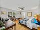 Well-lit bedroom with wooden desk, ceiling fan, and window, providing a comfortable and functional space at 121 Greenfield Rd, Winter Haven, FL 33884