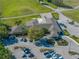 Aerial view of a clubhouse with a parking lot and manicured landscape, showcasing its attractive exterior and convenient access at 121 Greenfield Rd, Winter Haven, FL 33884