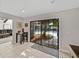 Bright dining area featuring tile floors and a sliding glass door with a view of the outdoor pool area at 121 Greenfield Rd, Winter Haven, FL 33884