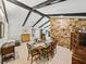 Spacious dining room featuring exposed beams, stone accent wall, and open layout at 121 Greenfield Rd, Winter Haven, FL 33884