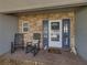 Inviting front porch with stone accents, rocking chairs, and a charming welcome decor at 121 Greenfield Rd, Winter Haven, FL 33884