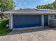 Spacious two-car garage with blue door offers ample parking and storage space at 121 Greenfield Rd, Winter Haven, FL 33884