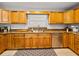 Well-lit kitchen with wooden cabinets, granite counters and stainless steel appliances at 121 Greenfield Rd, Winter Haven, FL 33884