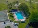 Aerial shot of an inviting outdoor pool with lounge chairs and lush landscaping, perfect for relaxation and recreation at 121 Greenfield Rd, Winter Haven, FL 33884