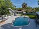 Aerial view of backyard with a private pool, patio, and lush landscaping at 121 Greenfield Rd, Winter Haven, FL 33884