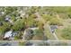 Aerial view shows home with mature trees, pool nearby, and defined lot lines, offering privacy and convenience at 1310 Walt Williams Rd, Lakeland, FL 33809