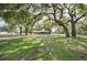 Expansive backyard view featuring lush green grass and mature shade trees at 1310 Walt Williams Rd, Lakeland, FL 33809