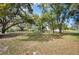 Picturesque backyard with large shade trees, grass, and plenty of open space at 1310 Walt Williams Rd, Lakeland, FL 33809