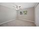 Cozy bedroom with a ceiling fan, carpet, and a large window at 1310 Walt Williams Rd, Lakeland, FL 33809