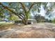 Exterior view of home's side and back, screened-in porch, and carport at 1310 Walt Williams Rd, Lakeland, FL 33809