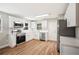 Modern kitchen with stainless steel appliances, white cabinets and countertops, and wood floors at 1310 Walt Williams Rd, Lakeland, FL 33809