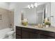 Well-lit bathroom features granite countertops, dark vanity, and shower-tub combination at 13119 Granger Ave, Orlando, FL 32827