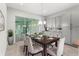 Cozy dining room with a view of the patio. The room is bright with a modern chandelier at 13119 Granger Ave, Orlando, FL 32827