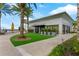 Restaurant building featuring manicured lawn, modern architecture, and outdoor seating, surrounded by palm trees at 13119 Granger Ave, Orlando, FL 32827