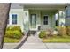 Inviting front porch with charming details and lush landscaping, offering a warm welcome at 13119 Granger Ave, Orlando, FL 32827