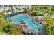 Aerial view of a luxury pool area with cabanas, sun loungers, and palm trees, perfect for relaxation and recreation at 13119 Granger Ave, Orlando, FL 32827