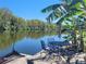 Waterfront dock with outdoor dining set, perfect for relaxing by the water at 1810 Blue Lake Dr, Lakeland, FL 33801