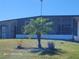 Front exterior view of home with well-maintained lawn and tropical landscaping at 1810 Blue Lake Dr, Lakeland, FL 33801