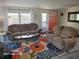 Comfortable living room featuring plush seating, bright rug, and lots of natural light at 1810 Blue Lake Dr, Lakeland, FL 33801