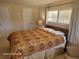 Inviting main bedroom with warm tones, two windows, and a cozy armchair for relaxation at 1810 Blue Lake Dr, Lakeland, FL 33801