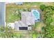 Overhead real estate shot showing roof and backyard pool, set within a verdant neighborhood at 2597 Highlands Vue Pkwy, Lakeland, FL 33812