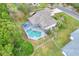 Real estate aerial showcasing backyard screened pool and landscaped yard in a residential area at 2597 Highlands Vue Pkwy, Lakeland, FL 33812