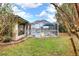 Lush backyard with landscaping that leads to a screened-in pool and patio area at 2597 Highlands Vue Pkwy, Lakeland, FL 33812