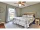 Cozy bedroom featuring a decorative ceiling fan, large arched window, and plush rug for added comfort and style at 2597 Highlands Vue Pkwy, Lakeland, FL 33812