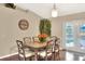 Cozy dining area features seating for six, with a view of the backyard and French doors to the patio at 2597 Highlands Vue Pkwy, Lakeland, FL 33812