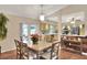 Dining area adjacent to the kitchen, featuring warm tones, seating for six, and views of the backyard at 2597 Highlands Vue Pkwy, Lakeland, FL 33812