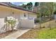 Exterior of the home featuring an access door to the fenced-in backyard at 2597 Highlands Vue Pkwy, Lakeland, FL 33812