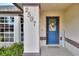 Close-up of the home's entrance, featuring a decorative door with address numbers and surrounding foliage at 2597 Highlands Vue Pkwy, Lakeland, FL 33812