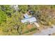 Aerial view of the property with a metal roof and surrounding trees at 3035 Linda Dr, Lakeland, FL 33810